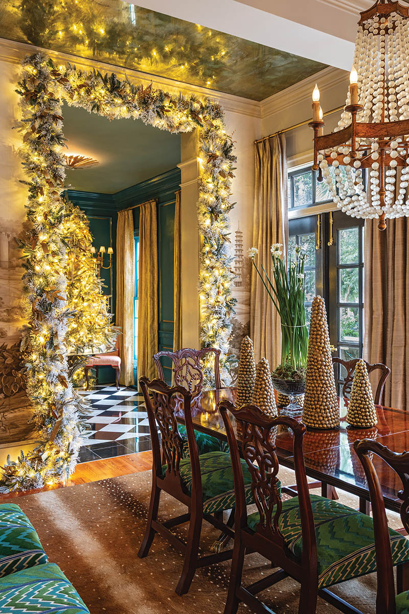 It’s all about layering: For the dining room’s winter wonderland, John adds dimension and volume to each tree and strand of garland through abundant candles, ornaments, and ribbon. But he also considers how complementary design elements—here, a collection of metallic tabletop trees, elegant potted paper-whites, and fluffy faux snow—will fully bring the space to life. After all, more is more during the holiday season.