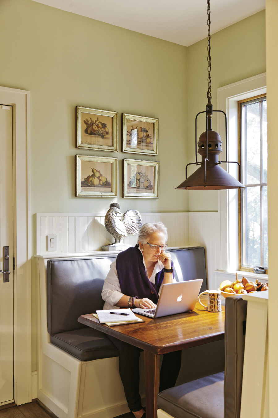 Becky Hollingsworth at work in the breakfast nook.