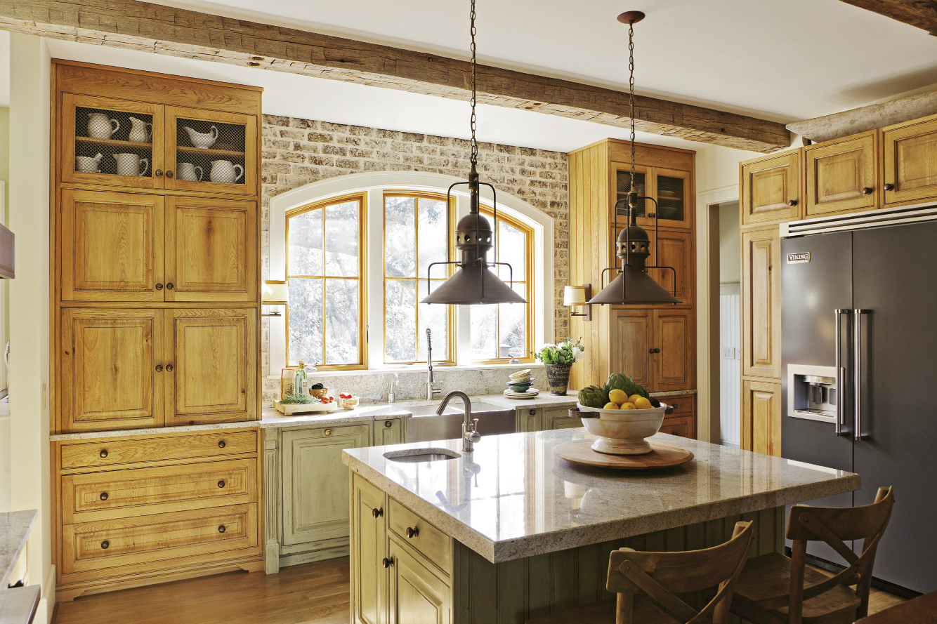 The couple’s furniture-style kitchen is composed of armoires and cabinets customized with varying finishes to create a collected look.