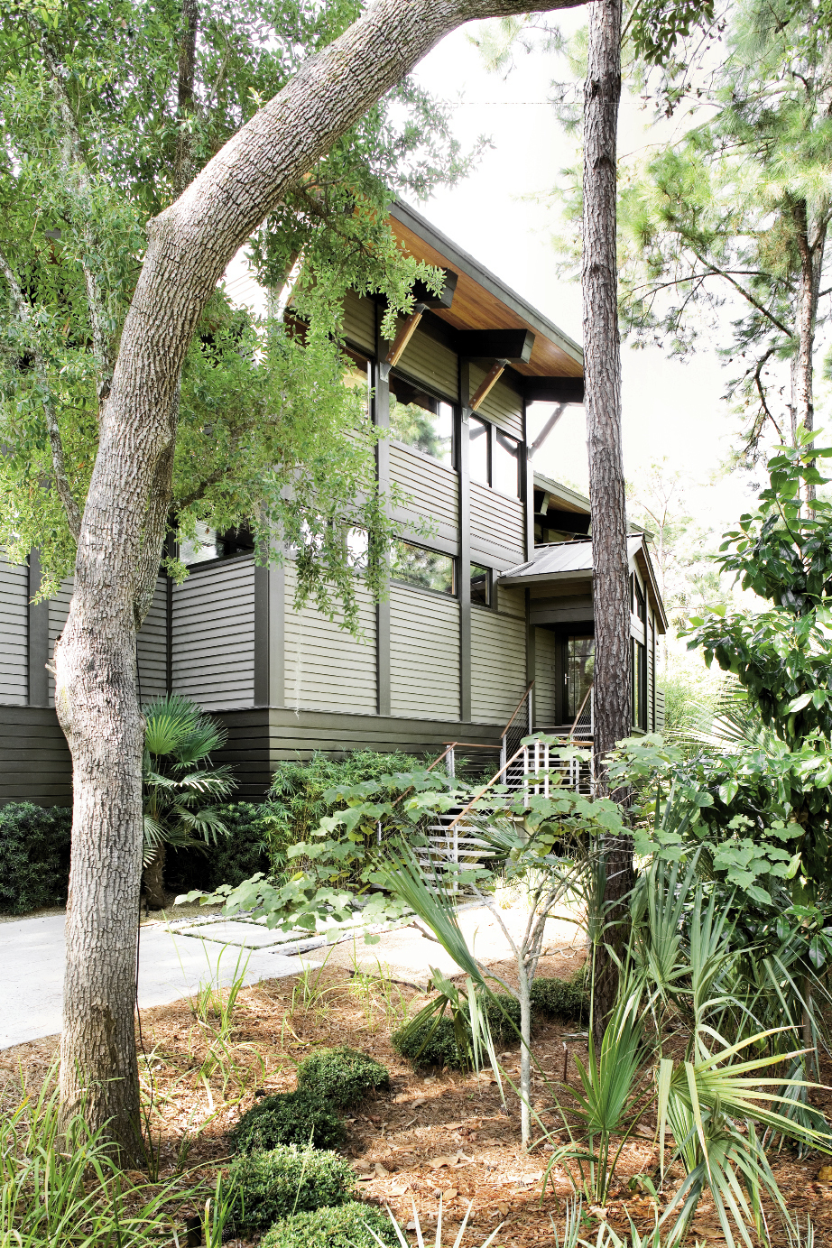 hingled siding on the street- facing exterior of Kathleen Parramore and Steve Sinn’s modern dwelling helps integrate it