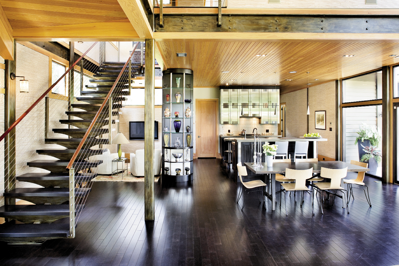 Cypress ceiling paneling, bamboo floors, stacked stone, and earthy grasscloth offset the contemporary structure’s hard edges.