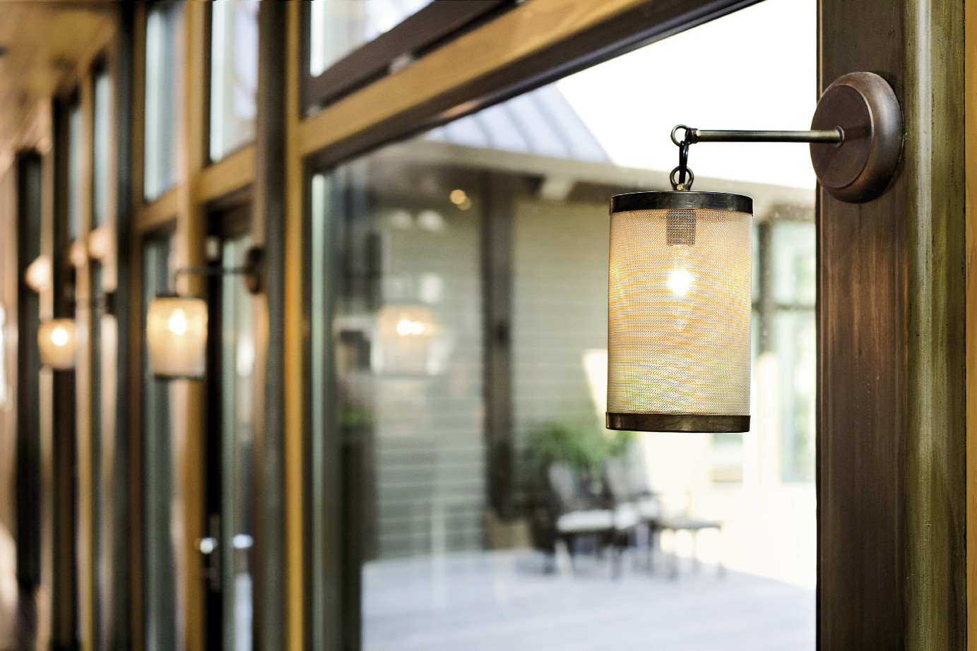 Hand-forged Italian lanterns warm the rear wall of windows.