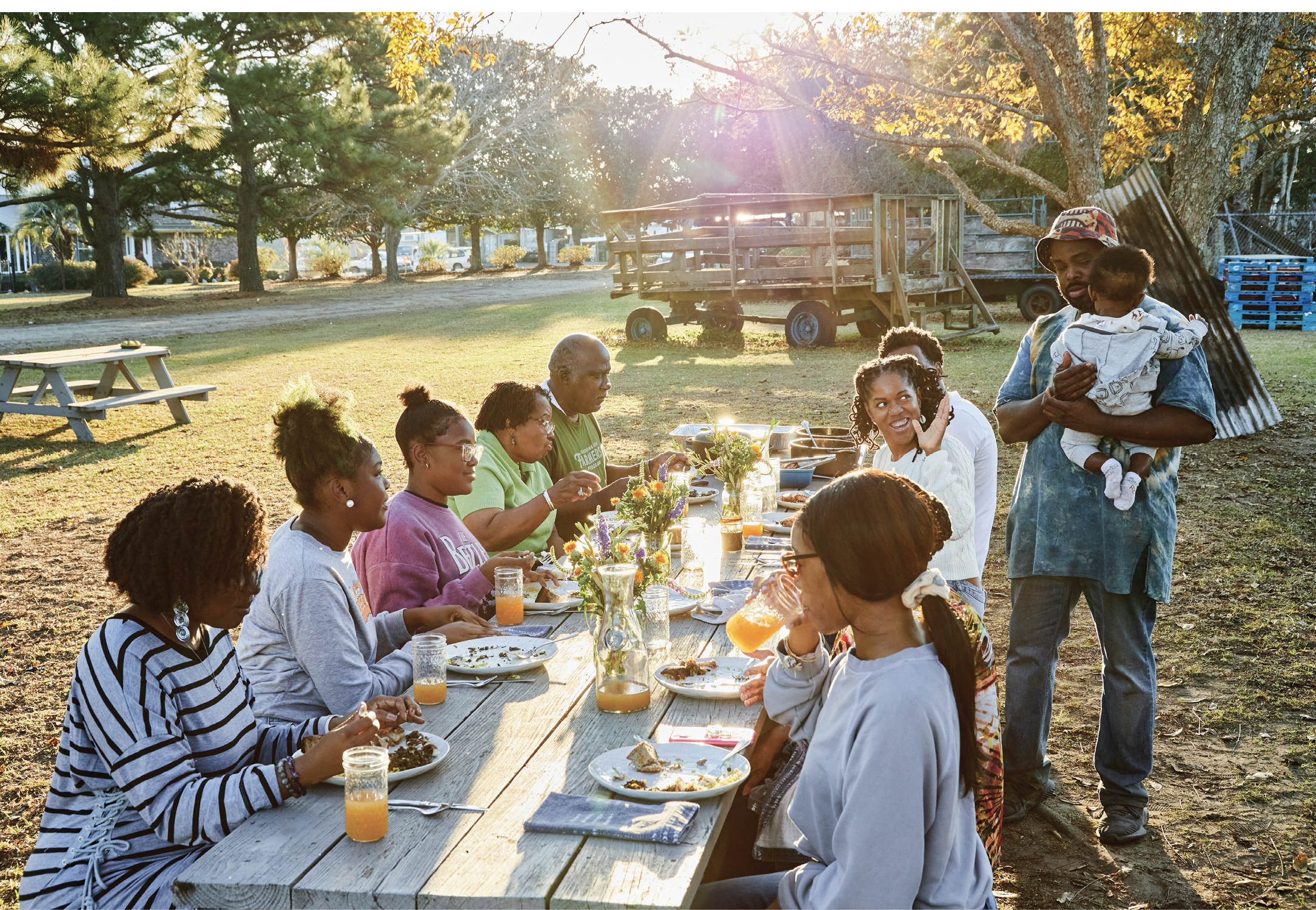 Gather Round: Dennis’s family and friends, including hosts Helen and Joseph Fields (in green), dig into the feast.