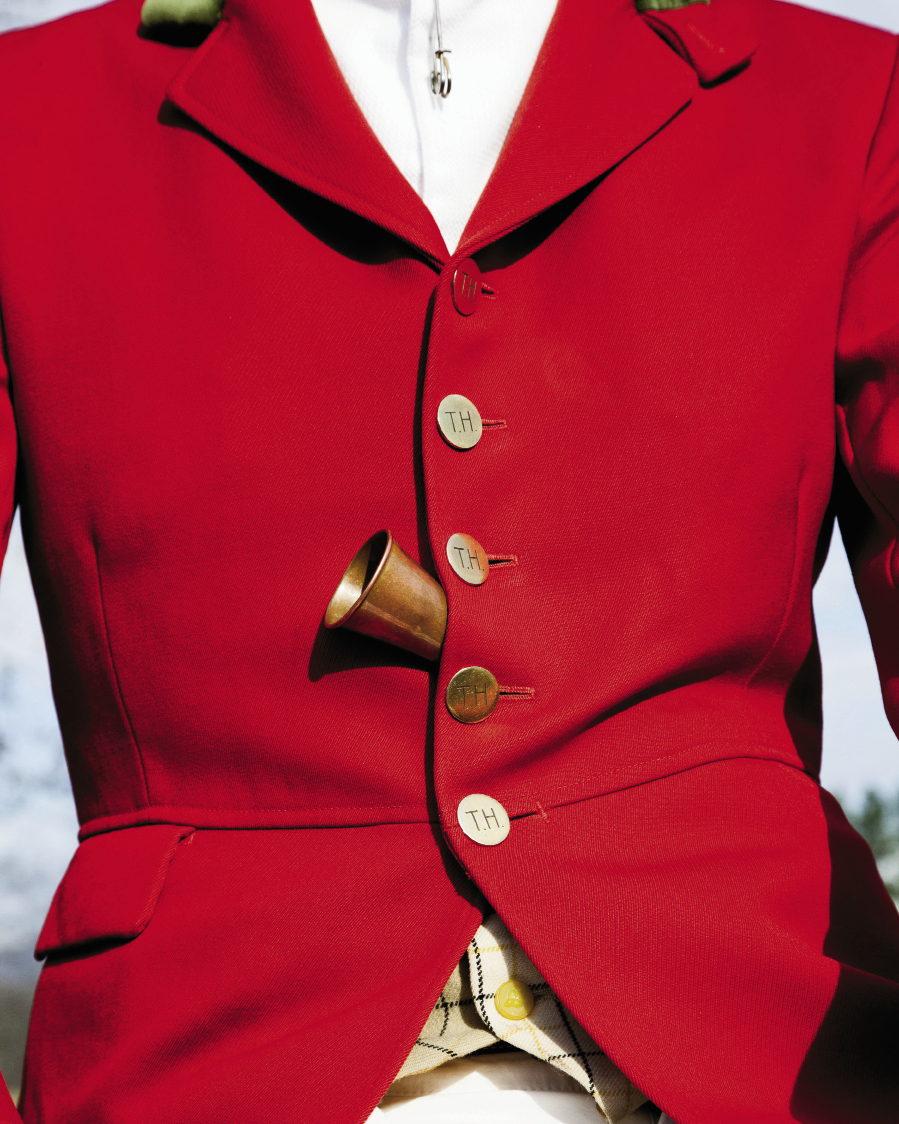 Huntsman Jordan Hicks sports a scarlet coat with buttons engraved with Tryon Hounds’ initials and uses an English-made horn to call to the yelping pack.
