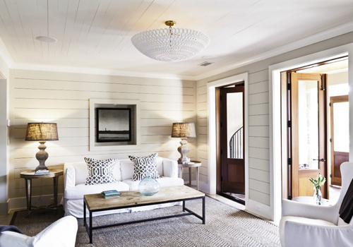 The ground-floor family room is part of the original cinder block structure and steps out to a slim screened porch.