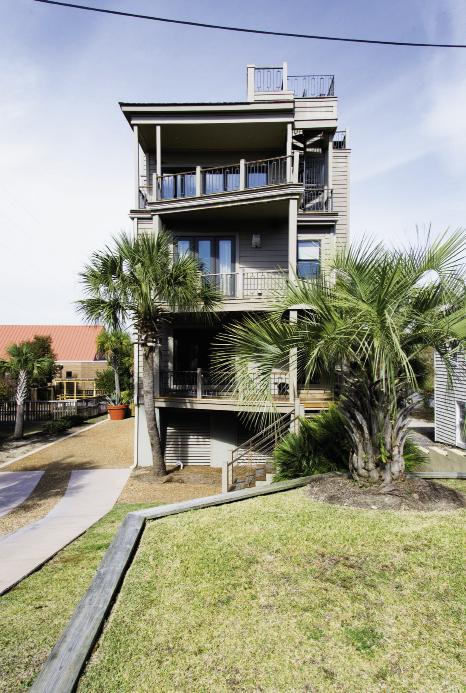 Box Set: Triangular decks offset the three-story home’s symmetrical stacked design.