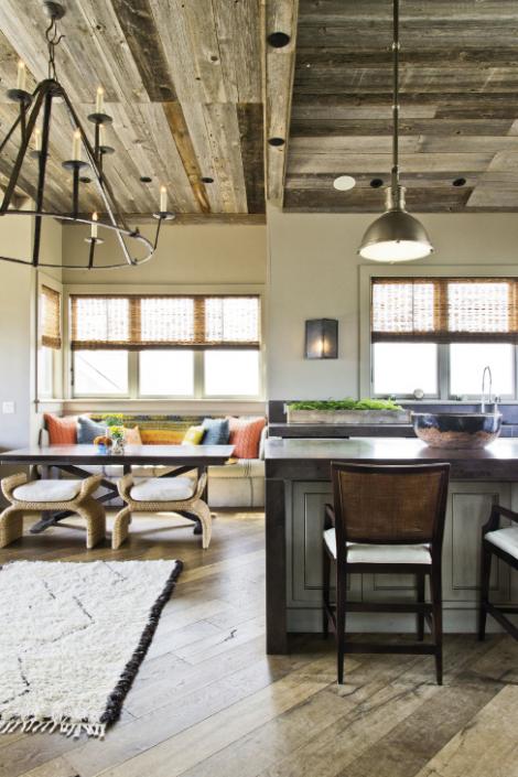 Seat Yourself: A vibrant banquette cozies up the third-floor penthouse. The woven stools are by Baker Furniture, the table by Hickory Chair, the banquette seating by local artisan Matt Decell, and the Kantha quilt from Celadon.