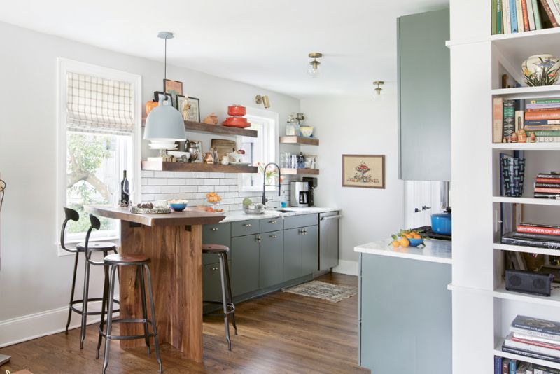 BEST SEAT IN THE HOUSE: The renovated kitchen is too small for a proper island, but no matter: a walnut bar fabricated by a close family friend delivers similar functionality. “This has become probably my favorite part of the house,” Jacques says. “It’s a great place for less formal meals or catching up while one of us is cooking.”