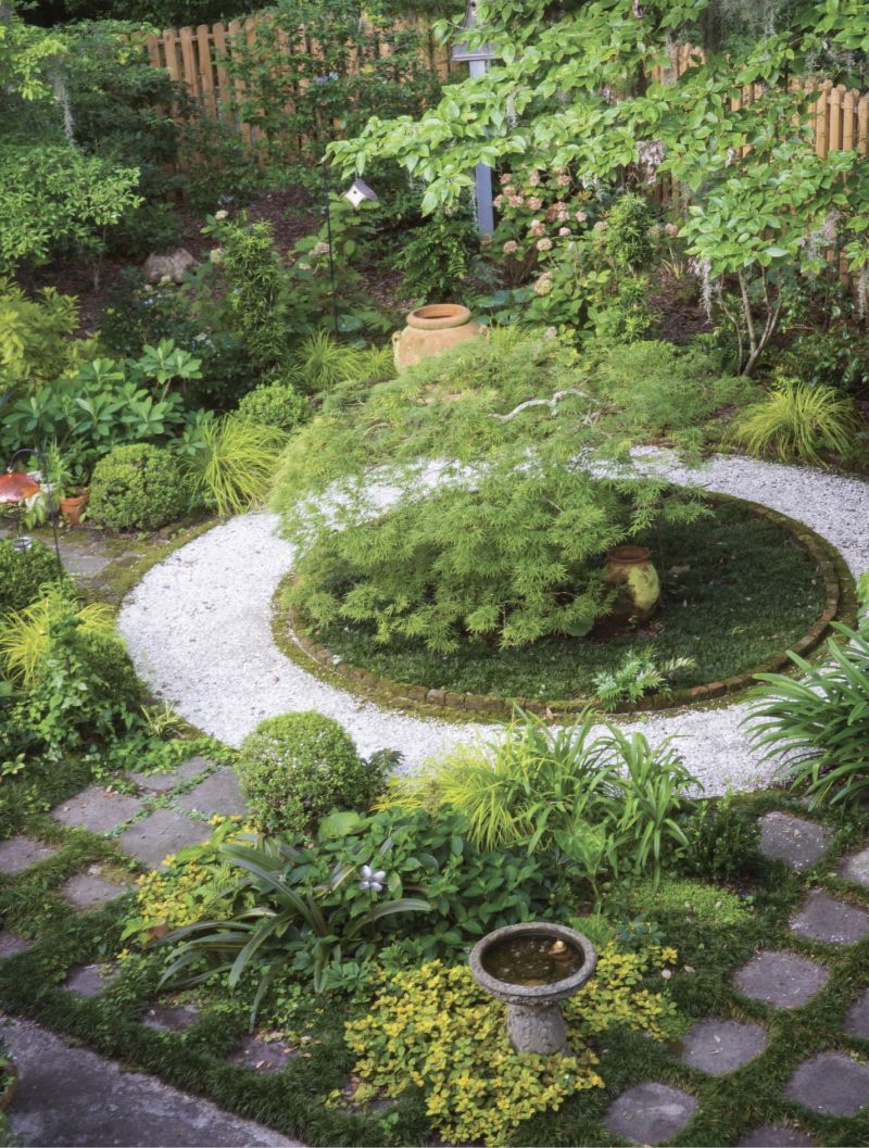 Geometry Rules: Rivers has always favored her shaded West Ashley backyard over the sunny front. Here, under the high canopies of three live oaks, a brick mason helped create a series of circles, squares, and rectangles around a central weeping Japanese maple. Ball-shaped boxwoods mark the entrances to paths leading deeper into the garden, which is filled with a richly textured array of plants that thrive in shade and dappled light.