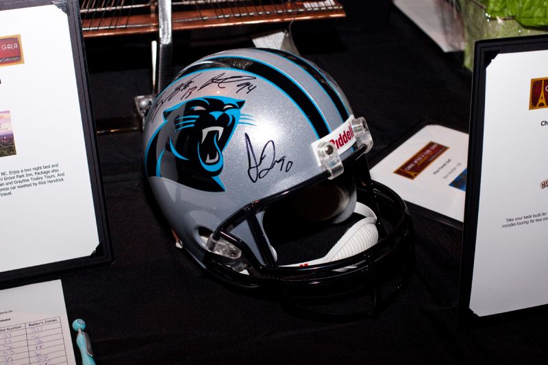 Attendees bid on an autographed Carolina Panthers helmet.
