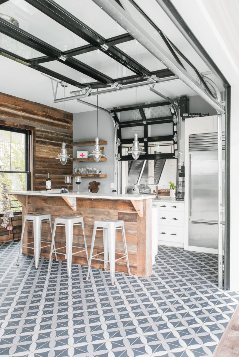 Open-Door Policy: A roll-up glass door connects the pool-house kitchen with the patio; a miniature version links to the outdoor bar and grilling station.