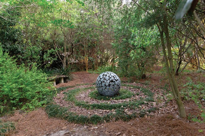 WISE CHOICE: Susan wanted a bit of elevation change and was concerned about flooding, so Angell designed a hill that features a swale to catch excess rainwater. At the top, Susan used mondo grass to form the shape of a nautilus—a marine mollusk associated with the growth of personal knowledge.