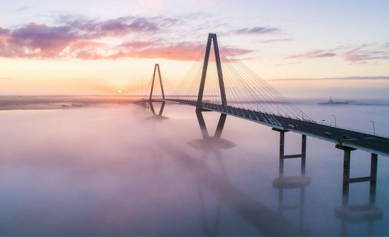“Sea Fog at Sunrise” {Altitude: 255 feet} In late February, a blanket of fog hovers below the Arthur Ravenel Bridge, reflecting the sunrise.