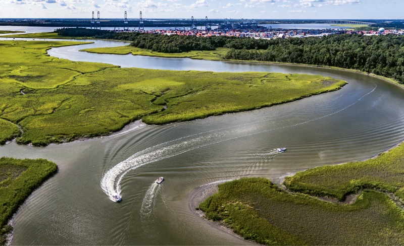 “Cooling Off on Hobcaw” {Altitude: 115 feet}  Pleasure boats cruise Mount Pleasant’s Hobcaw Creek while the port’s Wando Welch Terminal hosts a big ship during the dog days of summer.