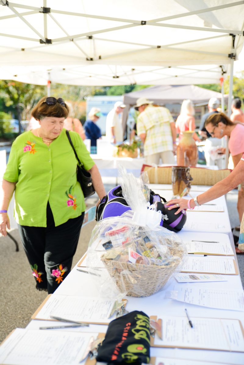 An attendee scans a few of the many auction items
