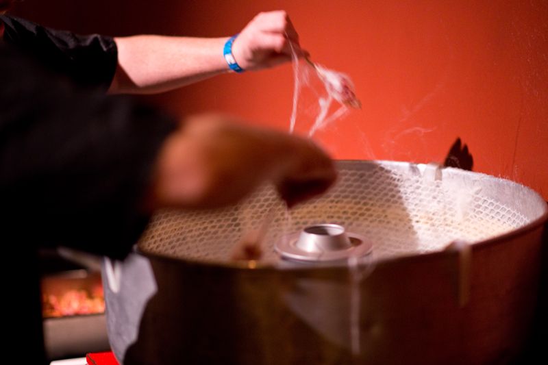 Bacon-infused cotton candy was twirled around a piece of bacon in a dish prepared by Cru Catering.