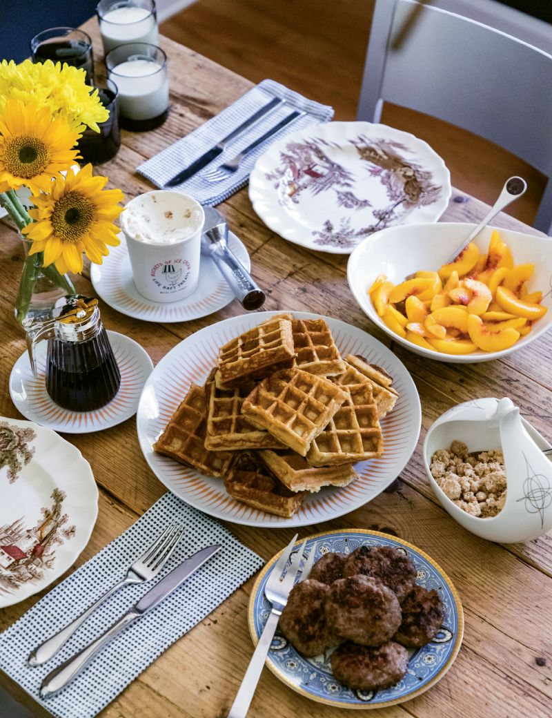 Breakfast at Harmon Manor (clockwise): local peaches, brown butter crumble, Storey Farms sausage patties, Anson Mills rice flour waffles, maple cheesecake ice cream