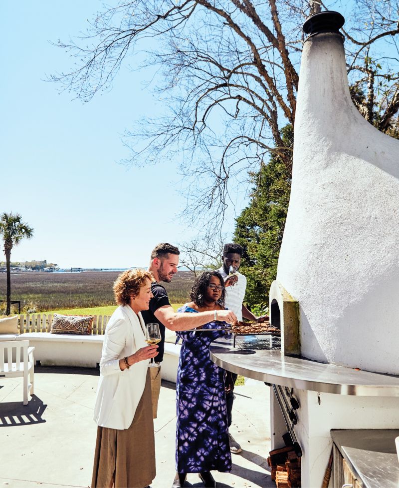 Callie White and Grace Oyediran await a special meal prepared by their sons.