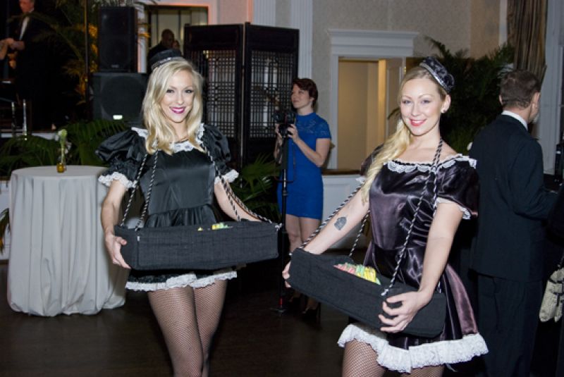 Maids serve up mustaches and candy cigarettes.