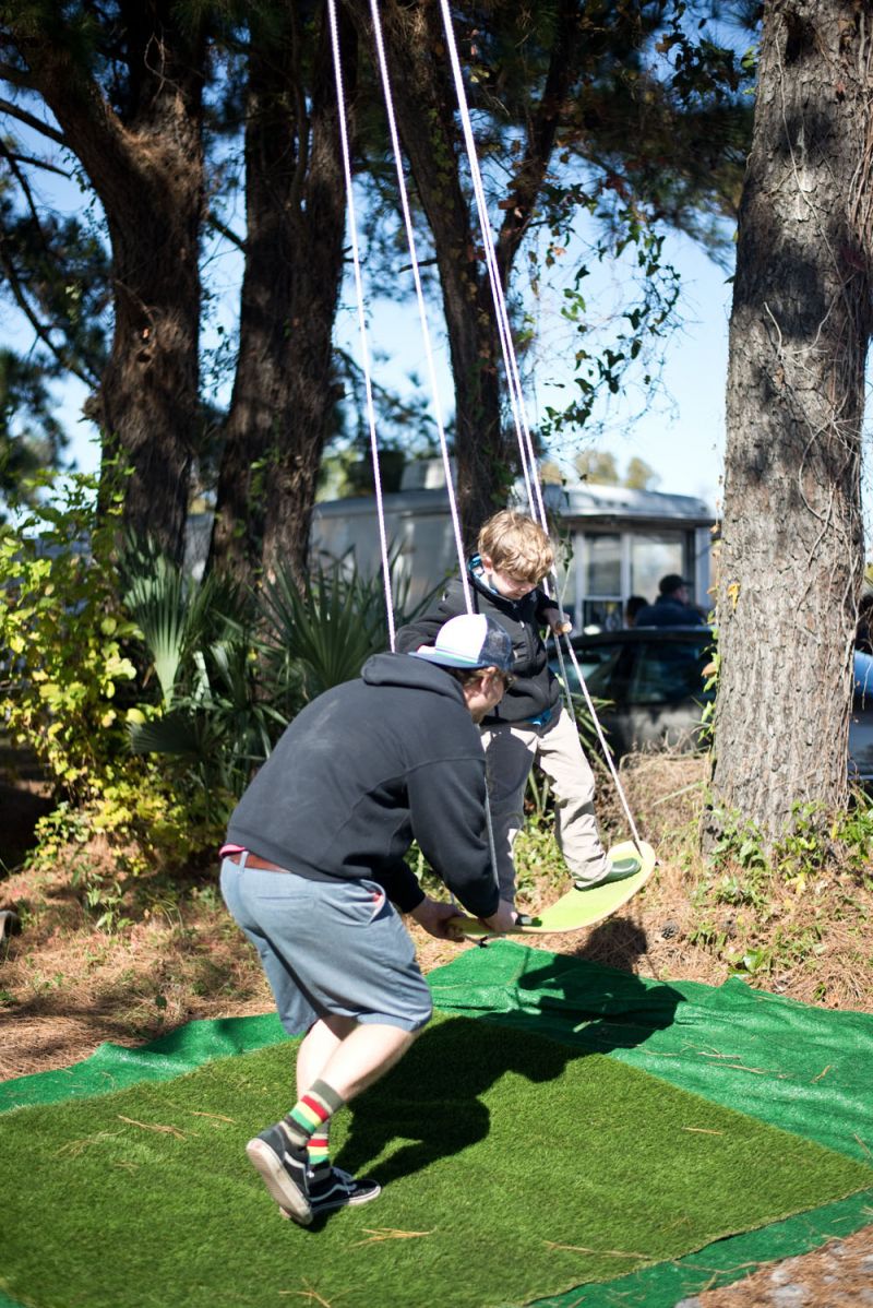 Rob Bertschy helped tots try out his backyard invention.