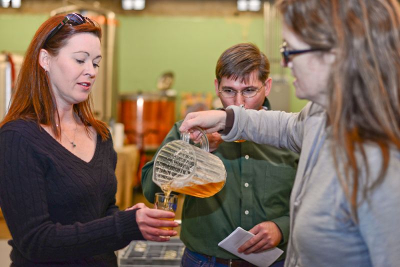 COAST Brewing co-owner Jaime Tenney gave tour-goers a sample.