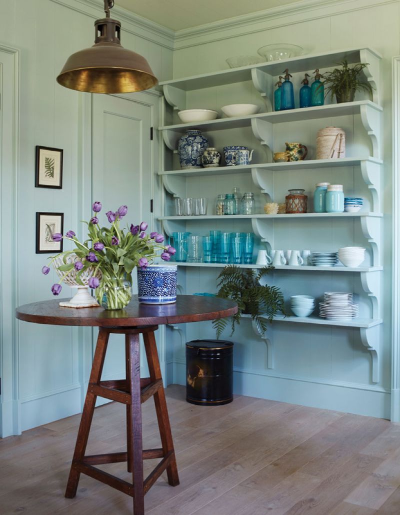 An antique table from Parc Monceau in Atlanta is highlighted by a burnished brass light fixture from Urban Electric.