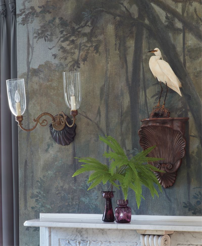 This hand-painted mural of a cypress swamp by artist Raymond Goins provided a unique starting point for a thoughtful re-imagining of an 18th-century single house’s dated interiors.