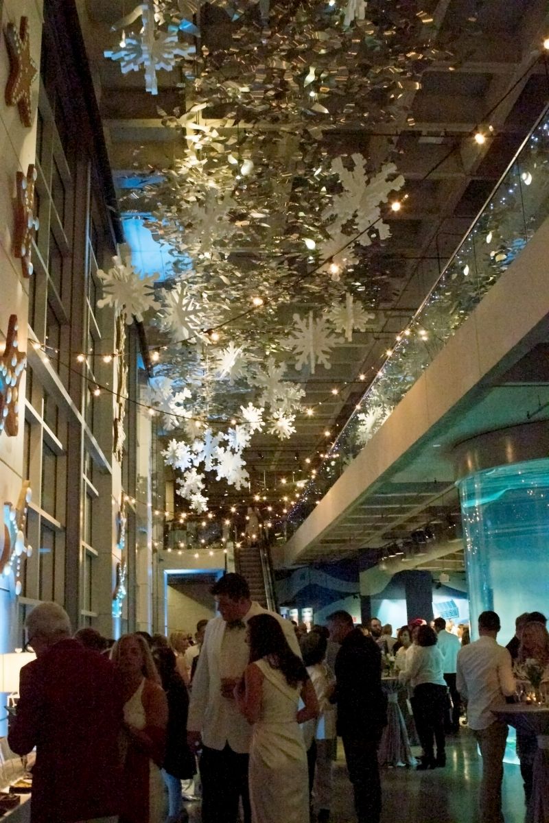 Patrons observe auction items beneath the elaborate decor.