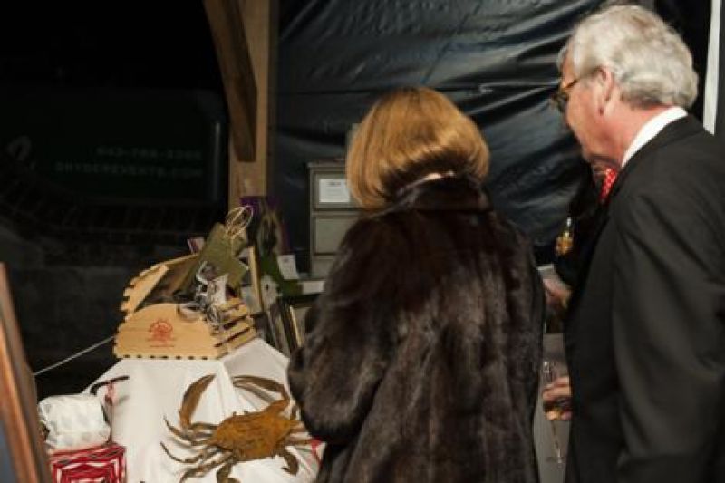Partygoers browse more than 70 silent auction items
